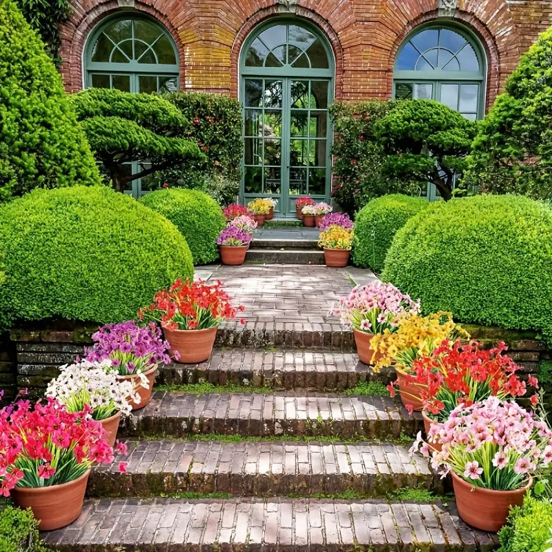 Garden on the sides of a staircase leading to three glass doors with green outlines